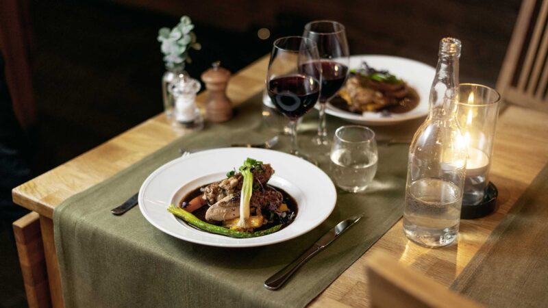 Close-up of 3-course dinner, Chicken with vegetables and a glass of red wine