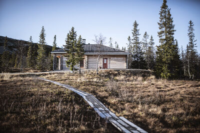En spång som leder fram till Fjällvistet i solen på sommaren